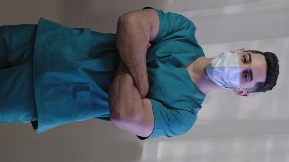 Vertical View Hispanic Male Nurse Man Wear Medical Mask Doctor in Uniform Look at Camera Posing with alt