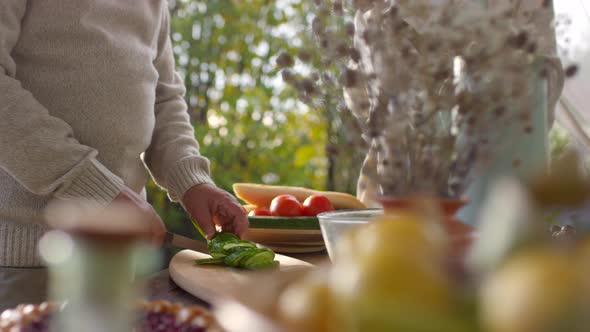 Middle-Aged Couple Setting up Table for Lunch in Garden alt