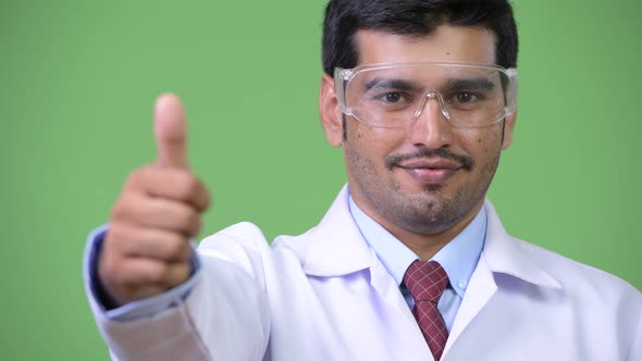 Young Handsome Persian Man Doctor Wearing Protective Glasses Giving Thumbs Up