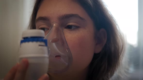 Close Up Shot of Childhood Asthma Inhaling Mask Illnesses Little Girl Doing Aerosol Independently alt