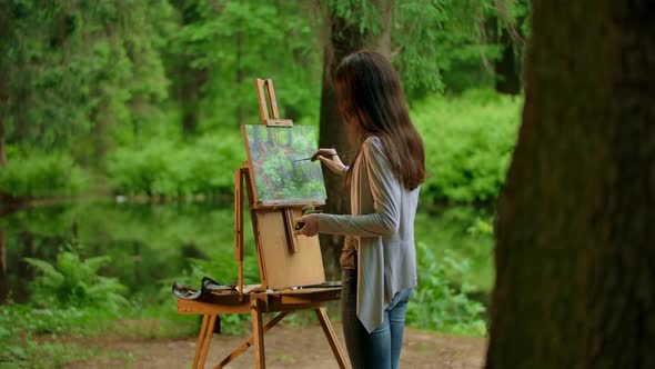 Attractive Slender Brunette Female Drawing a Picture alt