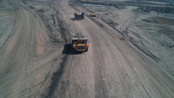 Top View of Yellow Dump Truck with Garbage Rock in Coal Mining