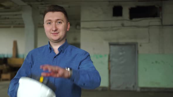An Engineer in a White Helmet Shows a Thumb Up alt