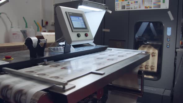 Large industrial digital printer printing sheets of paper alt