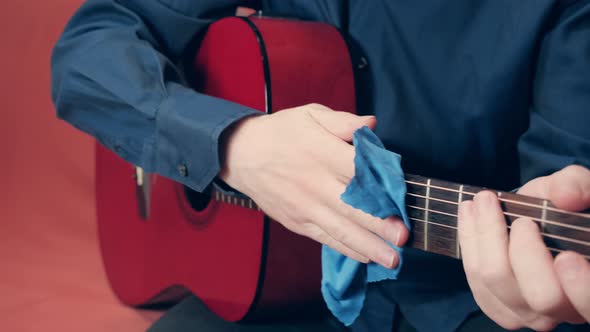 Men Hands Take Care of Acoustic Guitar Wiping Tool From Dust