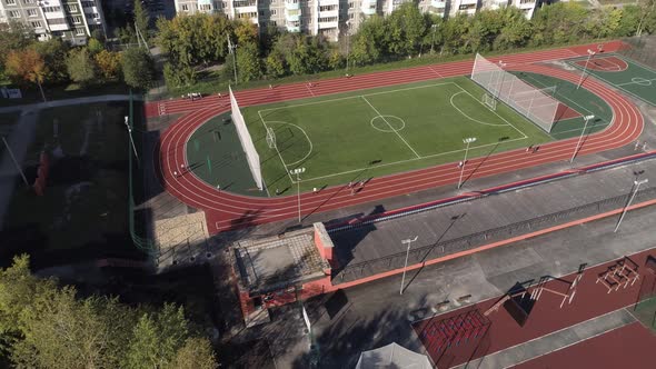 People run on treadmills at the stadium in the yard in the city 05 alt