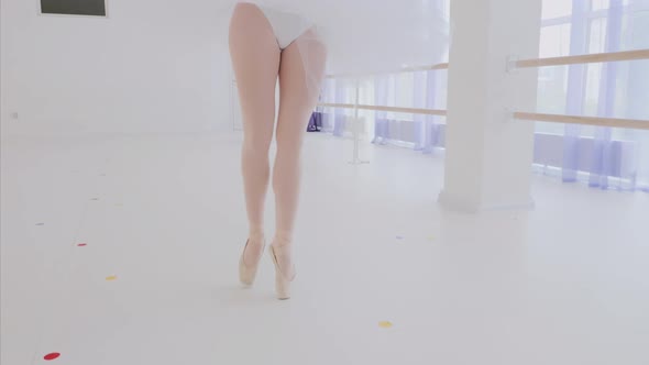 Young Girl Ballet Dancer in White Tutu is Spinning in Dance in Ballet Class