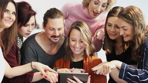 Group of business people looking at tablet during a meeting