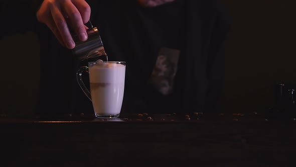 A Close-up of a Male Barista Making a Sweet Coffee Drink