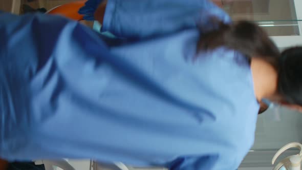 Vertical Video Stomatologist Performing Examination and Taking Care of Teeth alt