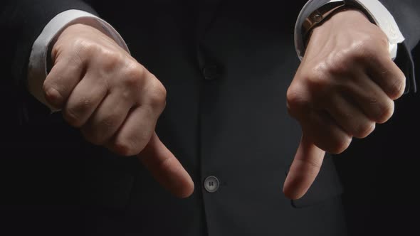 Businessman show the gestures by hands: dislike and fist