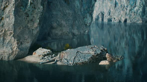 Rocky Cliffs in the Ocean at Sunny Day alt
