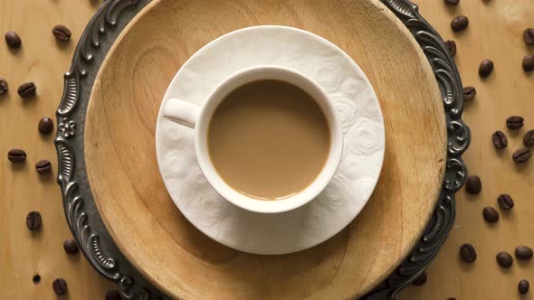 Top View of Coffee with Milk on Decorative Plate on Wooden Table