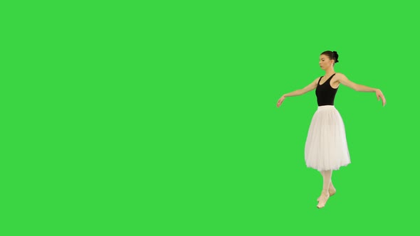 Young Ballerina Walks Demipointe Performing Some Ballet Movements on a Green Screen Chroma Key