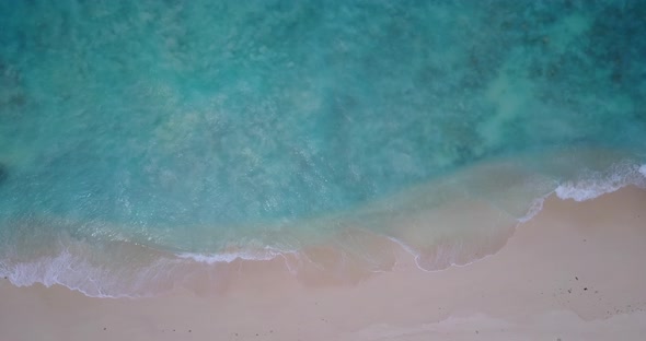 Wide angle birds eye island view of a white sandy paradise beach and aqua turquoise water background alt
