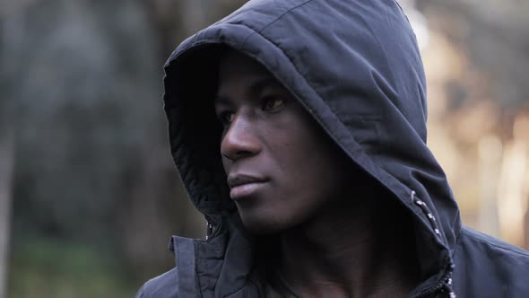 Thoughtful young black african attractive man with hood-outdoor alt
