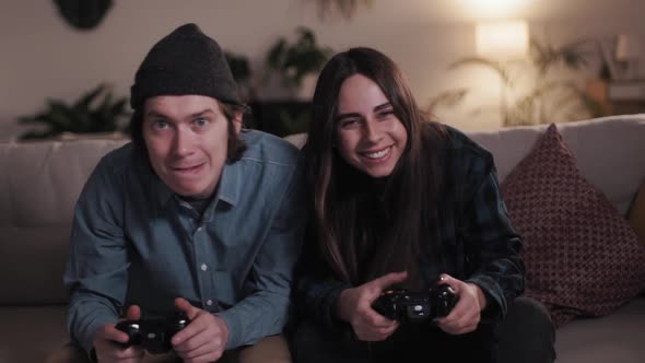 Home Isolated. Competitive Couple Push and Shove Each Other As They Play a Video Game at home