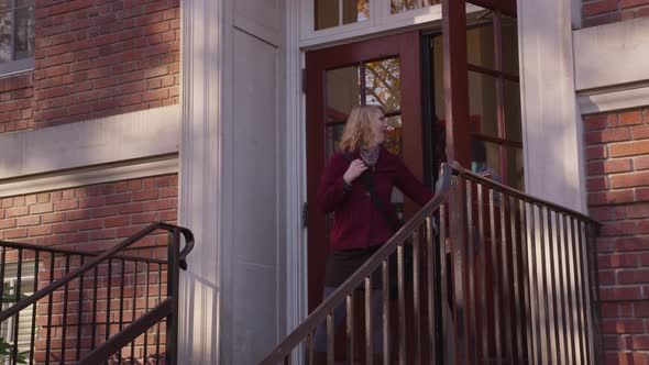 Two college students on campus walking down stairs