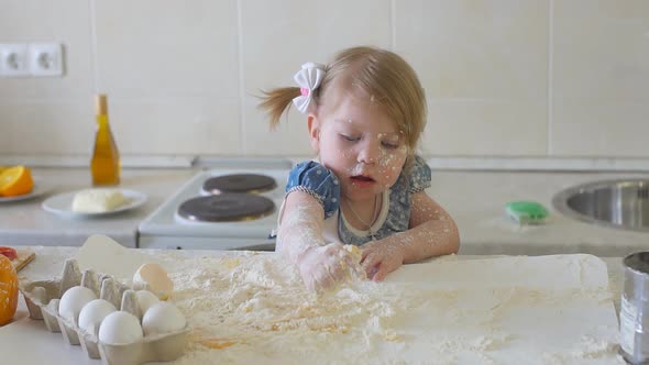 Happy Little Girl in the Kitchen Playing with Flour, Slow Motion