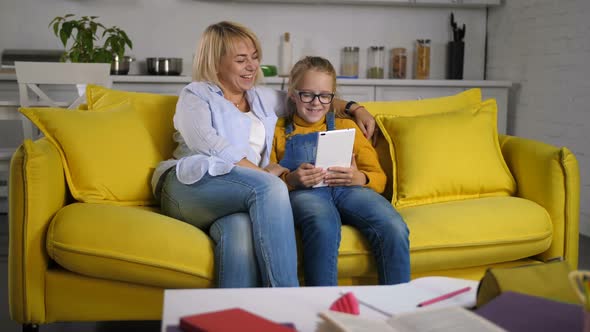 Joyful Family on Sofa Relaxing with Tablet Pc alt