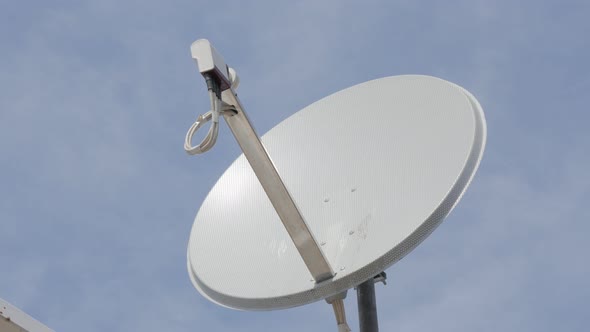 Satellite dish antena against blue sky slow panning 4K 2160p UltraHD footage - Dish antena and LNB c alt