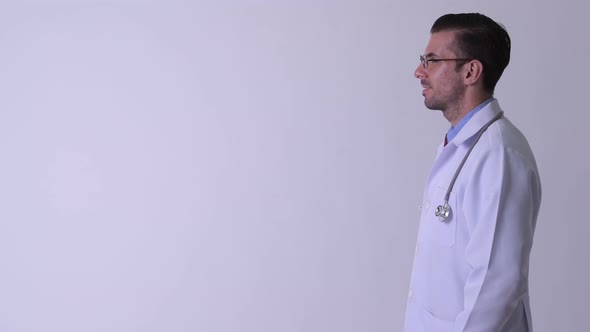 Profile View of Young Happy Hispanic Man Doctor Smiling alt