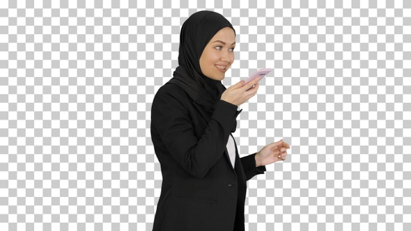Muslim girl in hijab using smartphone, Alpha Channel alt