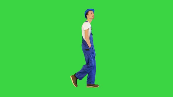 Walking Construction Worker in a Helmet on a Green Screen Chroma Key