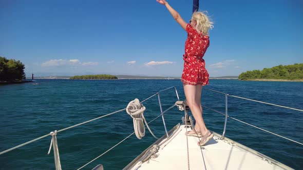 Girl Greeting with Her Hand on Sailboat alt