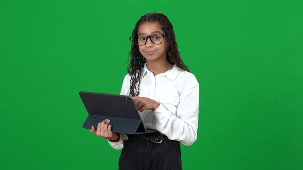 Genius African American Teen Girl Using Tablet Showing I Got an Idea Gesture on Green Screen alt
