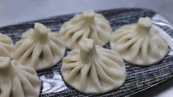 Traditional Georgian dumplings, Khinkali, with minced meat on a plate alt
