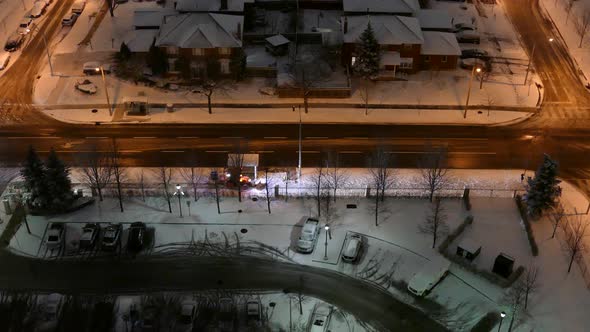 Top night view of frozen downtown residential area after heavy snowfall with street. Wide shot alt