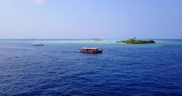 Tropical above copy space shot of a white sand paradise beach and blue water background in hi res 4K alt