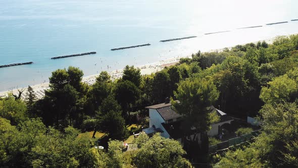 Epic Aerial Shot of House on Green Tree Hill with Amazing View of Summer Sunny Mediterranean Sea