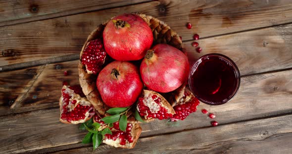 Grenades in Basket and Pomegranate Juice Slowly Rotating. 