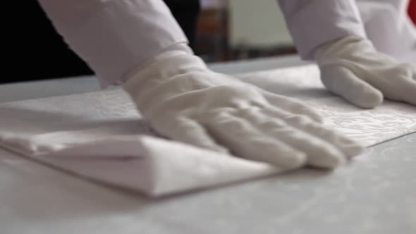 Beautiful view of how to fold a table napkin in white gloves