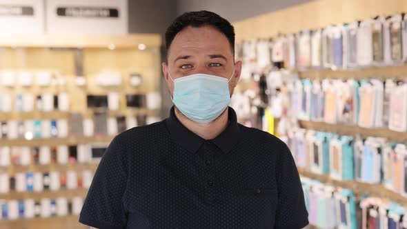 Portrait of Handsome Man Electronics Store Worker in Medical Mask