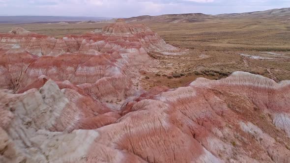 Flying up and over red desert hills to get aerial view of the Wyoming landscape alt