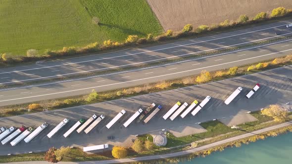 Top down aerial view of highway interstate road with fast moving traffic and parking lot with alt