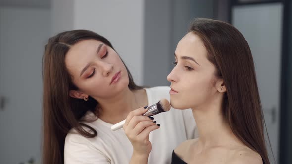 Makeup Artist Making Skin Ton for Client in Salon alt