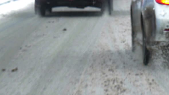 Traffic in city on dull winter day alt