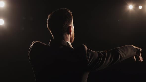 A Man is Performing Emotionally on Stage alt