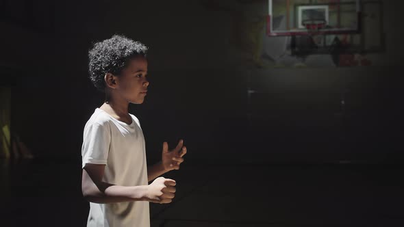 Boy Practicing Passing and Catching Basketball alt