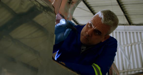 Engineer examining aircraft 4k alt