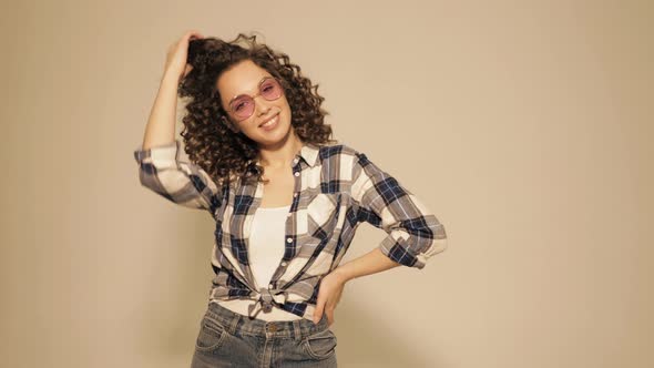Beautiful smiling model with afro curls hairstyle dressed in hipster clothes alt