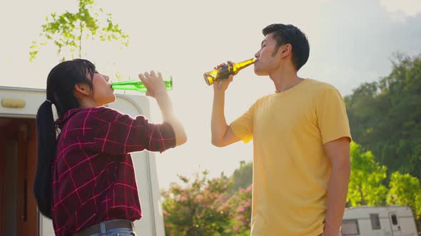 Group of Asian man and woman friends are having holiday party outdoor on camp in evening together. alt