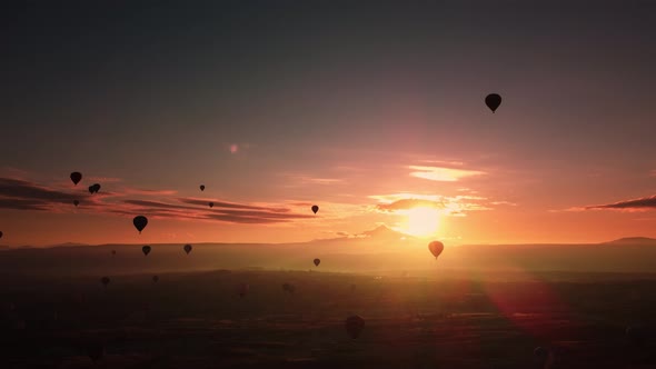 Aerial Footage of Plenty Levitating Hot Air Balloons in the Sky at Amazing Sunrise alt