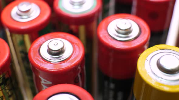 Red and Yellow Used Batteries in Heap