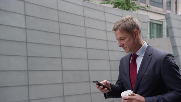 Businessman using smart phone and on the move