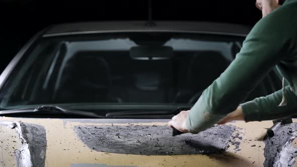 A Master with Loops in His Hands Displays the Shape of a Part. A Man Works on a Mock-up of a Sports alt